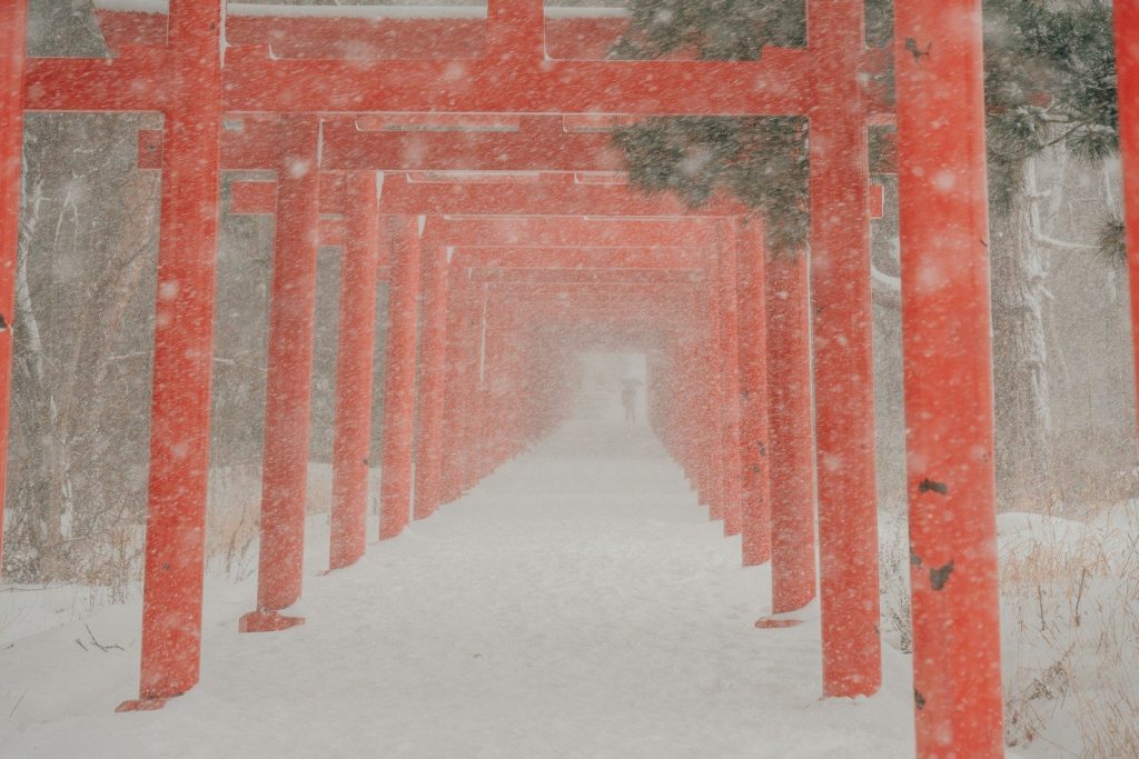 Snow-covered red torii gates at a shrine in Kyoto in winter