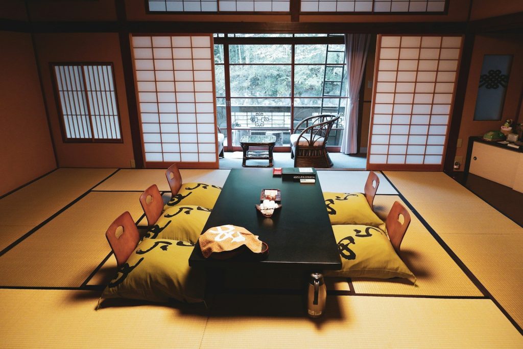Table and chairs on tatami mats in a traditional Japanese room