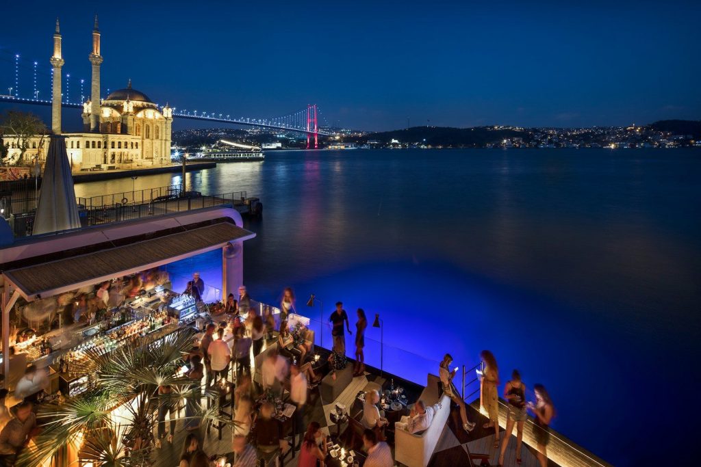 people at the pier near bridge during night