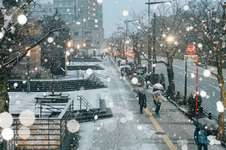 People walking along a snow-covered street in Japan in winter