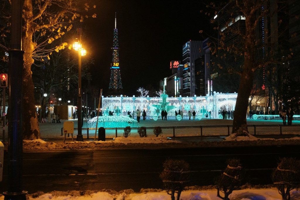 A city at night with a fountain in the foreground