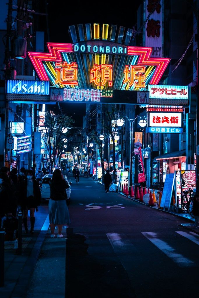 Neon-lit city street in Osaka at night in winter